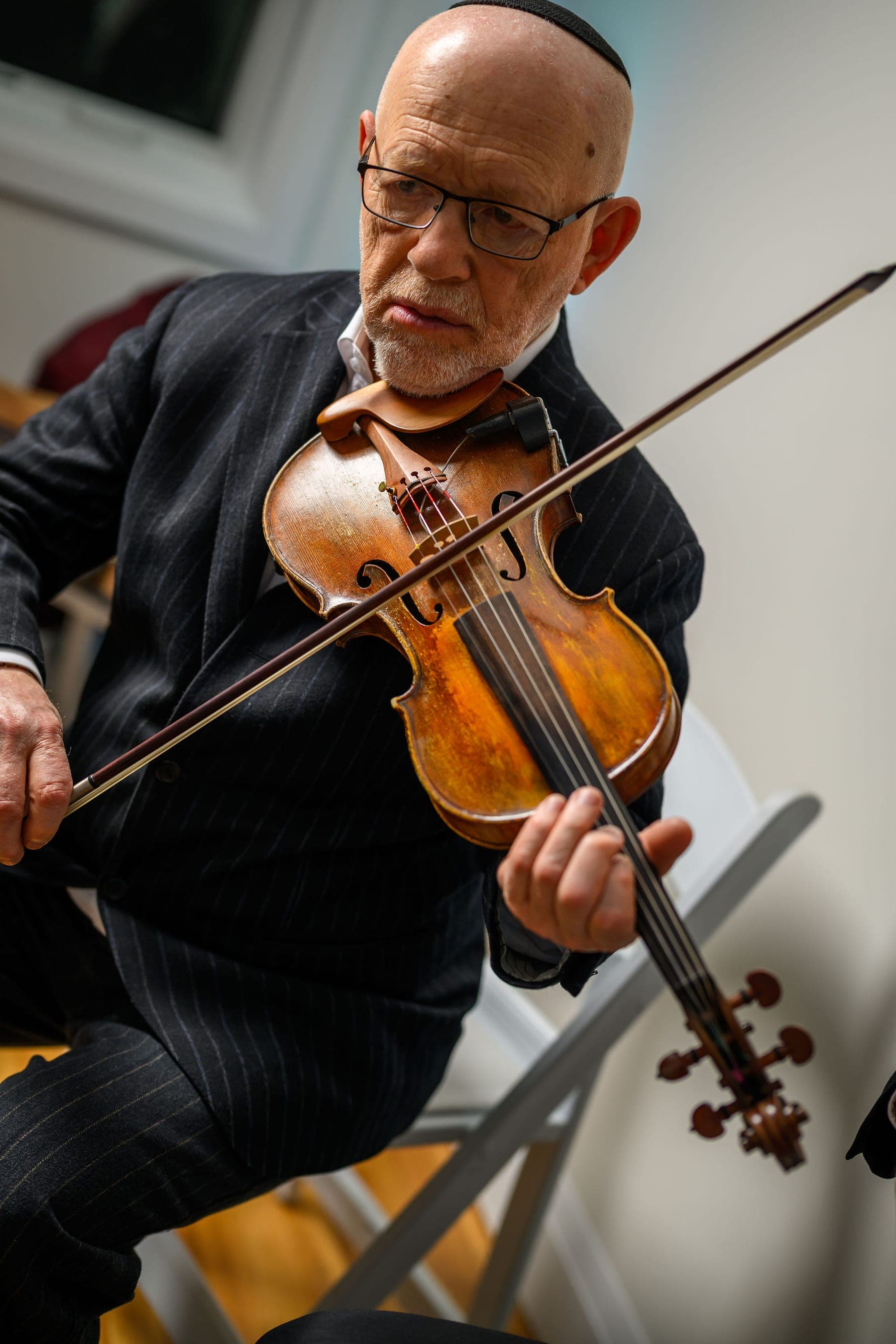 A violinist mid-bow, close up