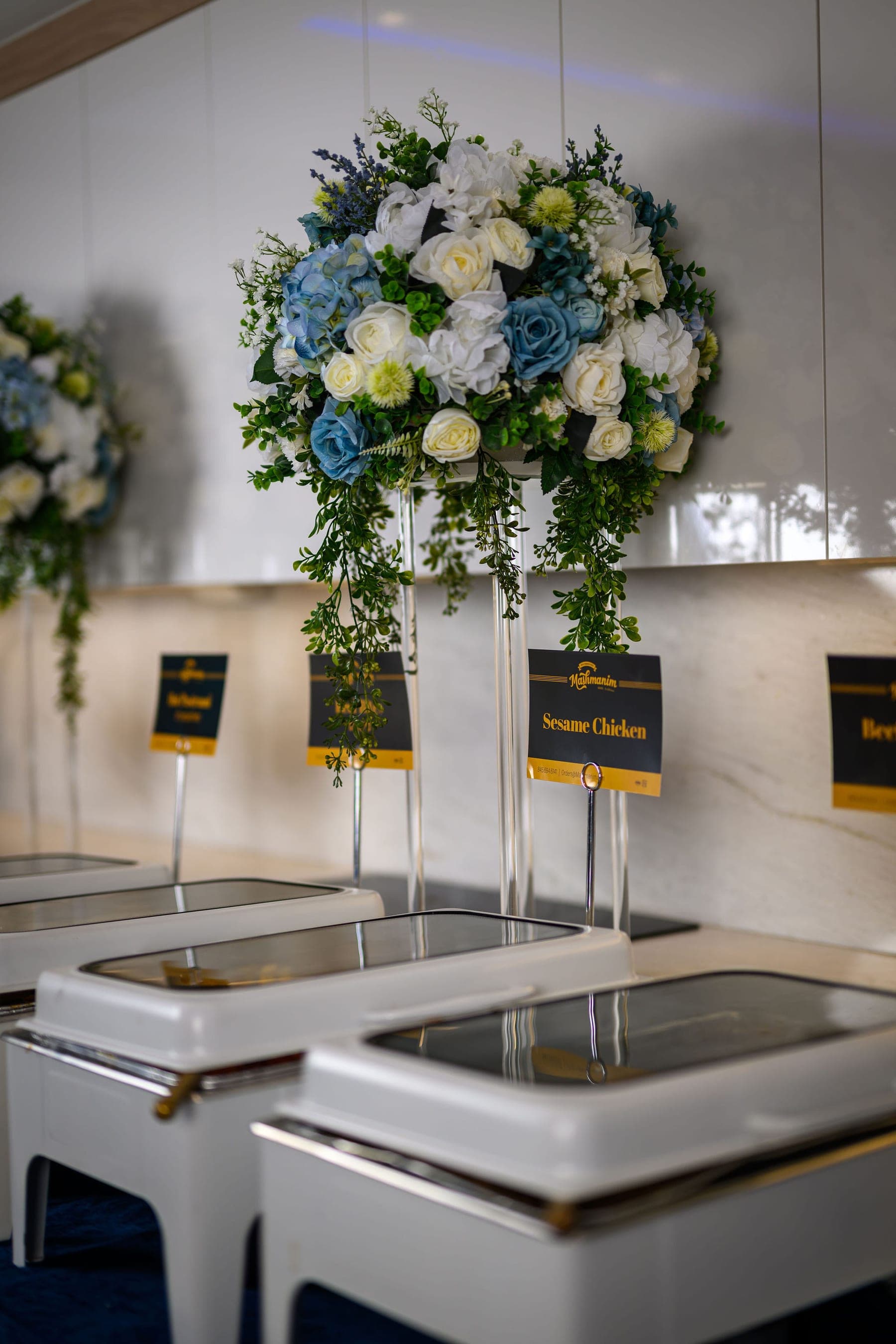 Floral arrangements above the line, a Sesame Chicken card beneath them